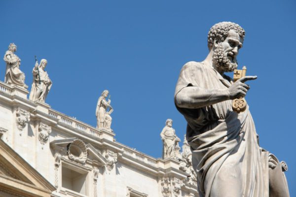 Statue of Saint Peter holding the keys of the Christian church in Saint Peter's Square Vatican City.